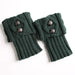 Pair of green knit leg warmers with two buttons