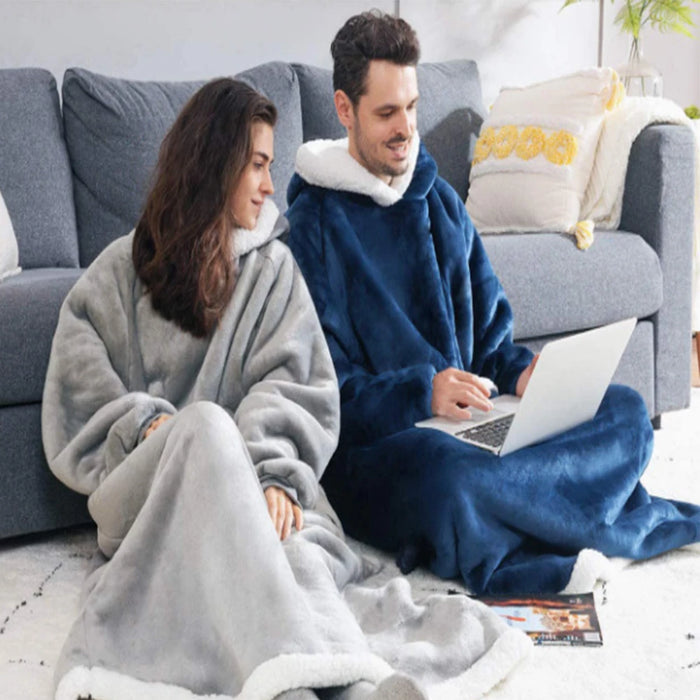 Couple on a sofa in grey and navy blanket hoodies