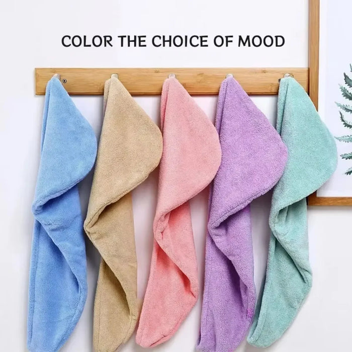 Coral fleece hair towels in blue, beige, pink, purple and mint hanging on hooks