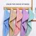 Coral fleece hair towels in blue, beige, pink, purple and mint hanging on hooks