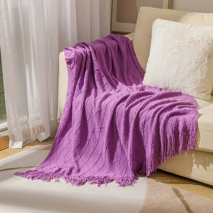 Purple diamond knit throw on a cream sofa