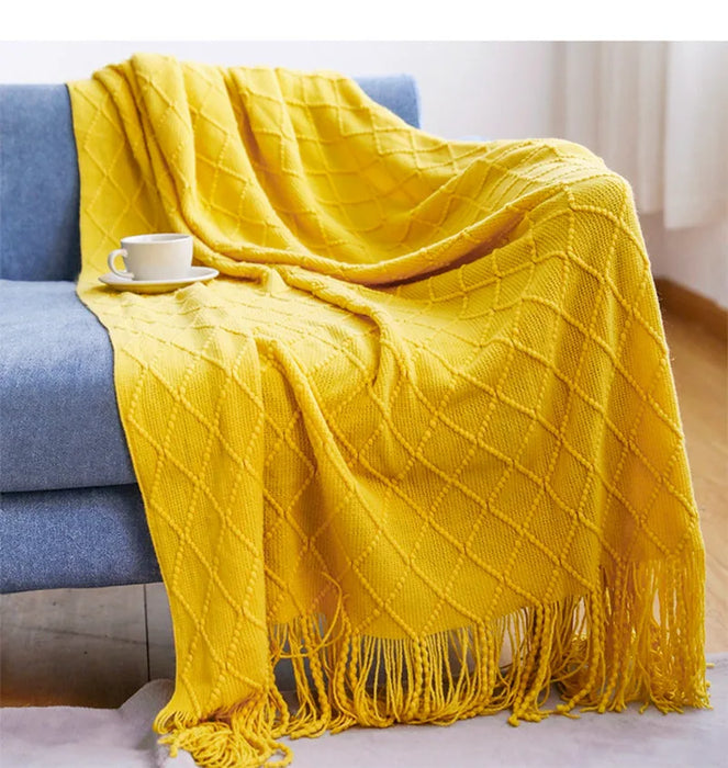 Yellow diamond knit throw on a sofa