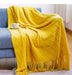 Yellow diamond knit throw on a sofa