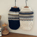 Navy and cream knit dog sweaters on hangers