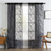 Black floral lace curtain panels in a living room