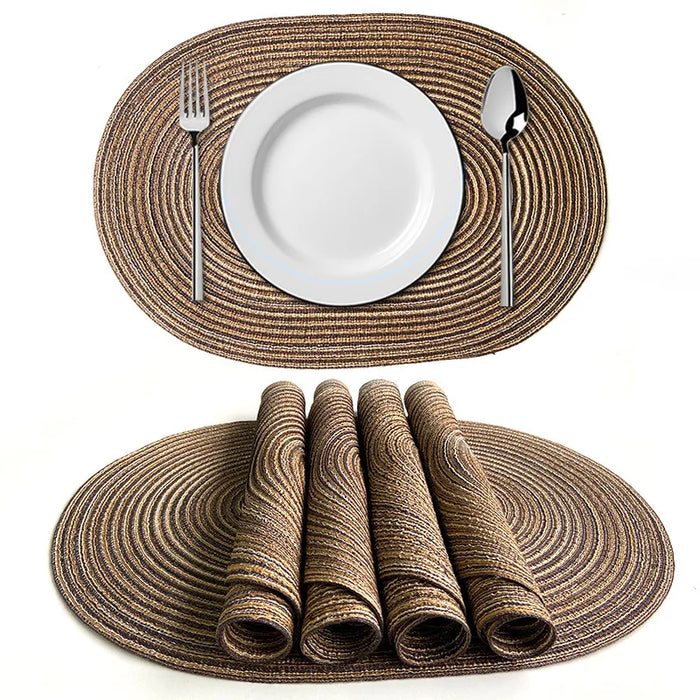Coffee oval braided placemats, one with a plate and a stack of rolled mats