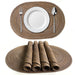 Coffee oval braided placemats, one with a plate and a stack of rolled mats