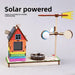 Solar weather station model with a painted house and wind vane