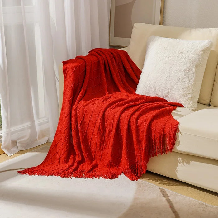 Red diamond knit throw on a cream sofa