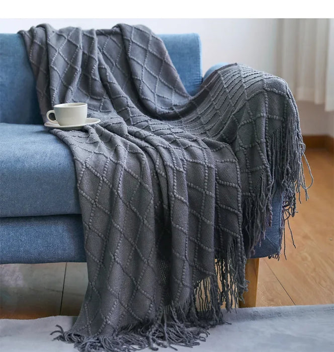 Grey diamond knit throw on a blue sofa