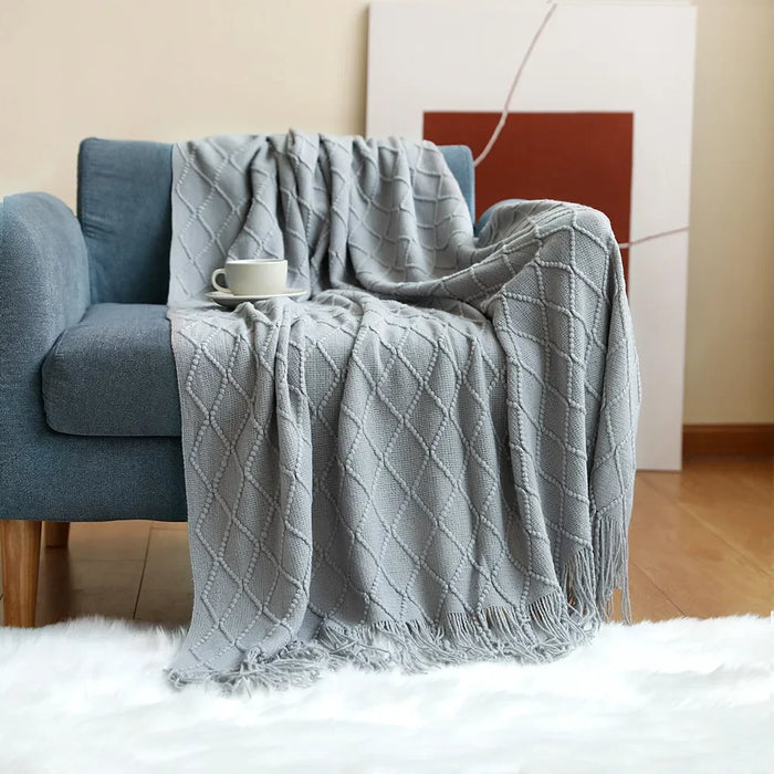 Light grey diamond knit throw on an armchair