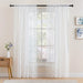 White floral lace curtain panels on a window