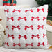 White cushion cover with raised red bows