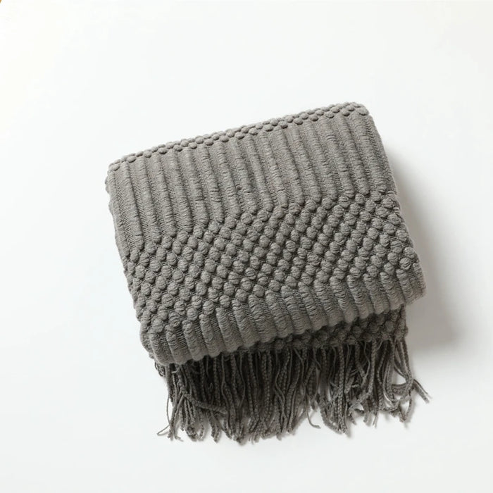Folded dark grey bubble knit throw