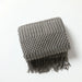 Folded dark grey bubble knit throw