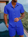 Man in a sapphire blue short sleeve shirt and shorts set