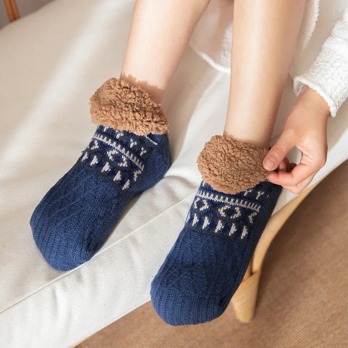 Person pulling on navy slipper socks