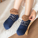 Person pulling on navy slipper socks