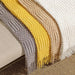 Grey, yellow and cream knitted throws with tassel fringe