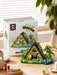 A-frame forest cabin set in front of its box