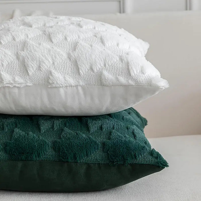 White and green plush tree cushions stacked