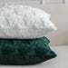 White and green plush tree cushions stacked