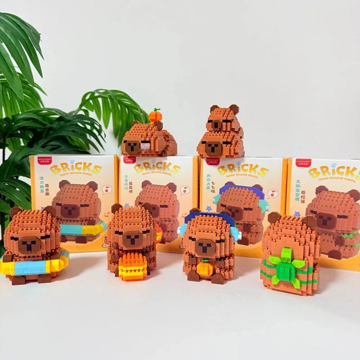 Capybara figures in front of their colour boxes