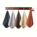 Mixed colour set of 5 hand towels on a rail