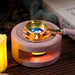 Pink wax melting stove lit by a tealight with wax melting in the spoon