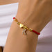 Initial heart charm bracelet with letter K on a wrist