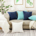 Navy, blue and white corduroy cushions on a beige sofa