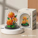 Orange chrysanthemum bouquet in a dome beside its colour box
