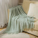 Light green diamond knit throw on a sofa