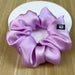 Lilac silk scrunchie on a white stand