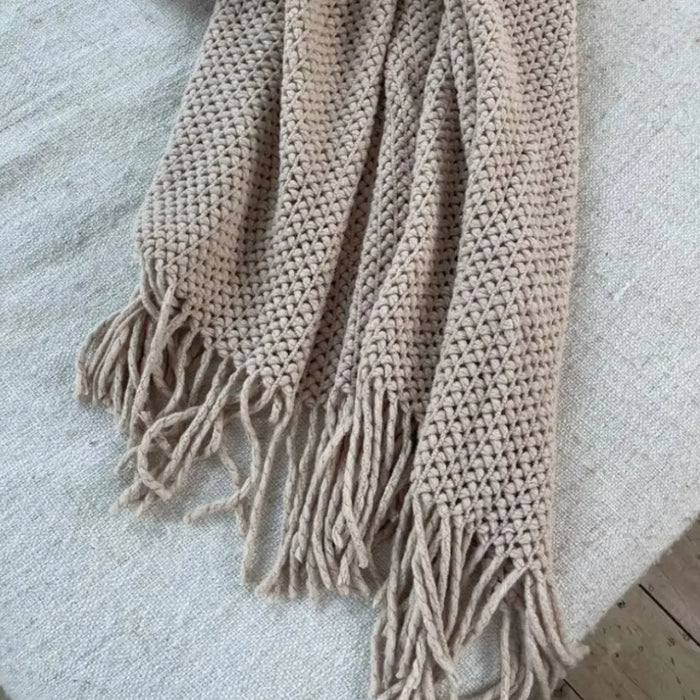 Khaki knit throw hanging with tassel fringe