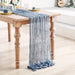 Grey blue gauze table runner on a white table