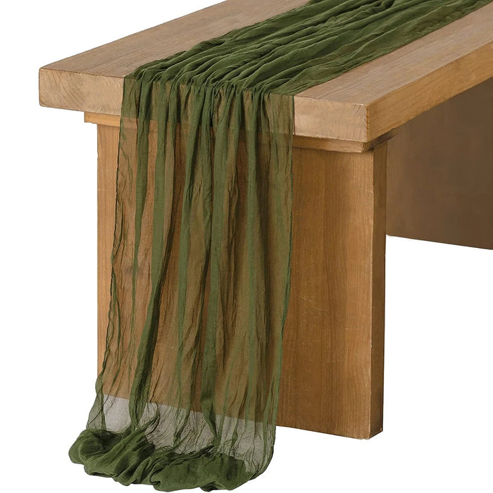 Olive gauze table runner over a wooden table