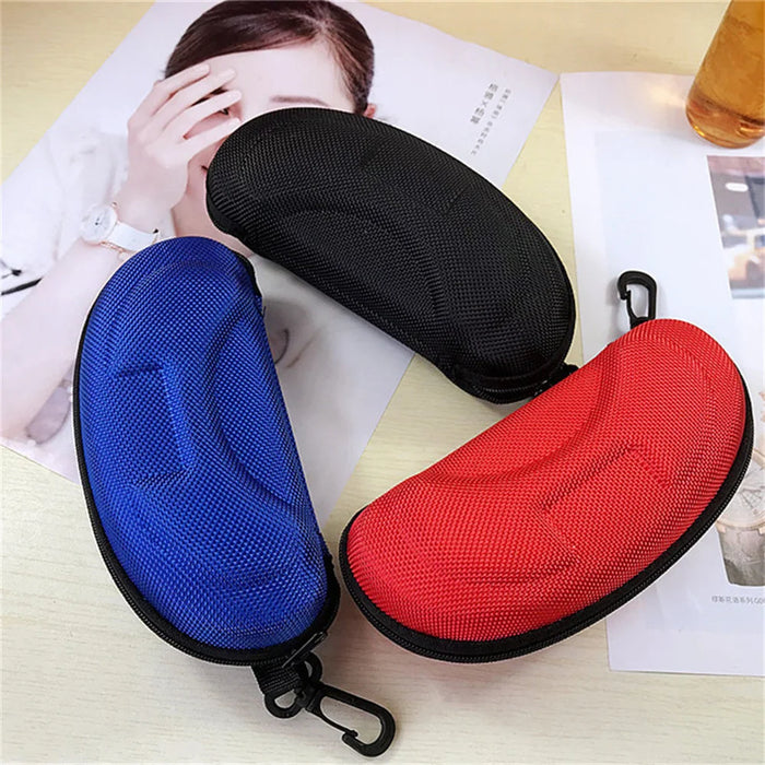 Black, blue and red sunglasses cases on a table