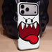 White cartoon ghost face phone case standing on a table