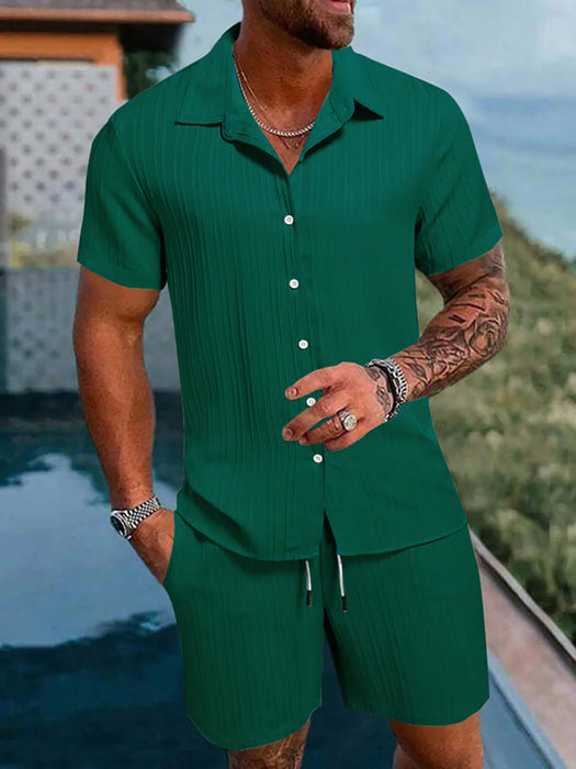 Man in a dark green short sleeve shirt and shorts set