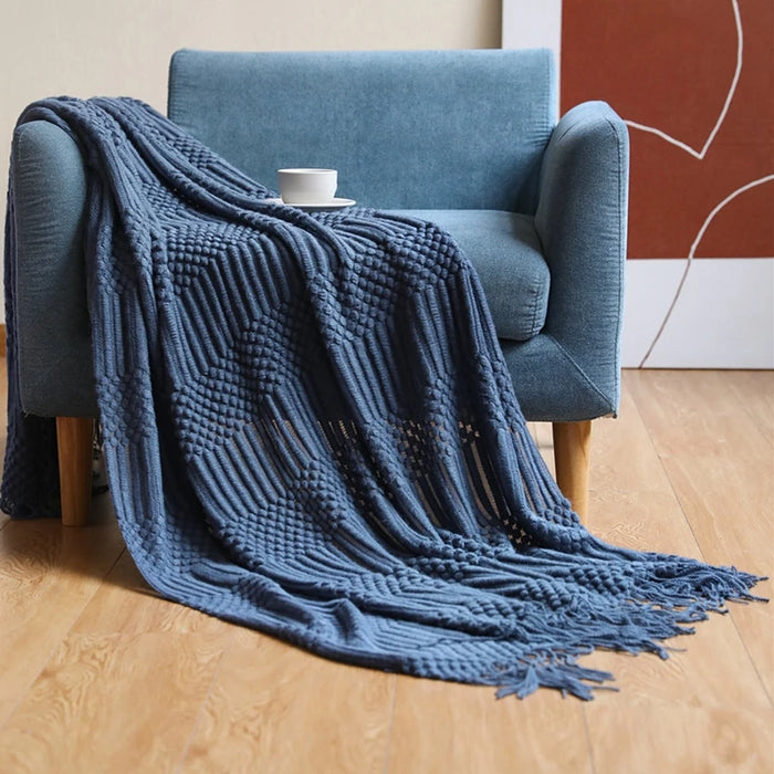 Navy bubble knit throw on a blue armchair