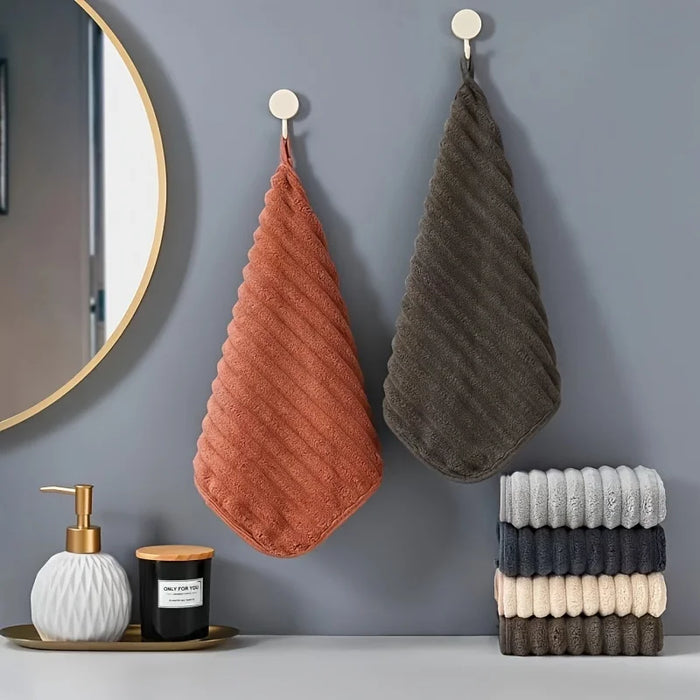 Rust and brown hand towels hanging in a bathroom