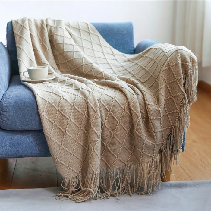 Khaki diamond knit throw on a blue sofa