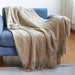 Khaki diamond knit throw on a blue sofa