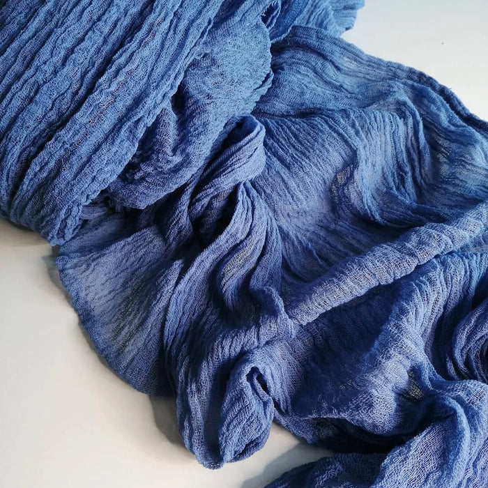 Close-up of a blue cheesecloth table runner