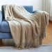 Khaki diamond knit throw on a blue sofa