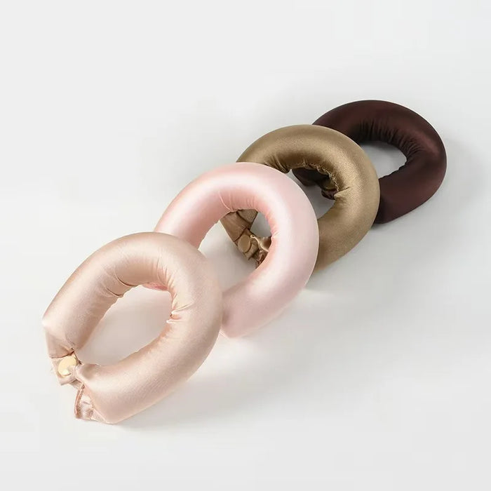 Satin curling rods in pink, champagne and brown snapped into rings