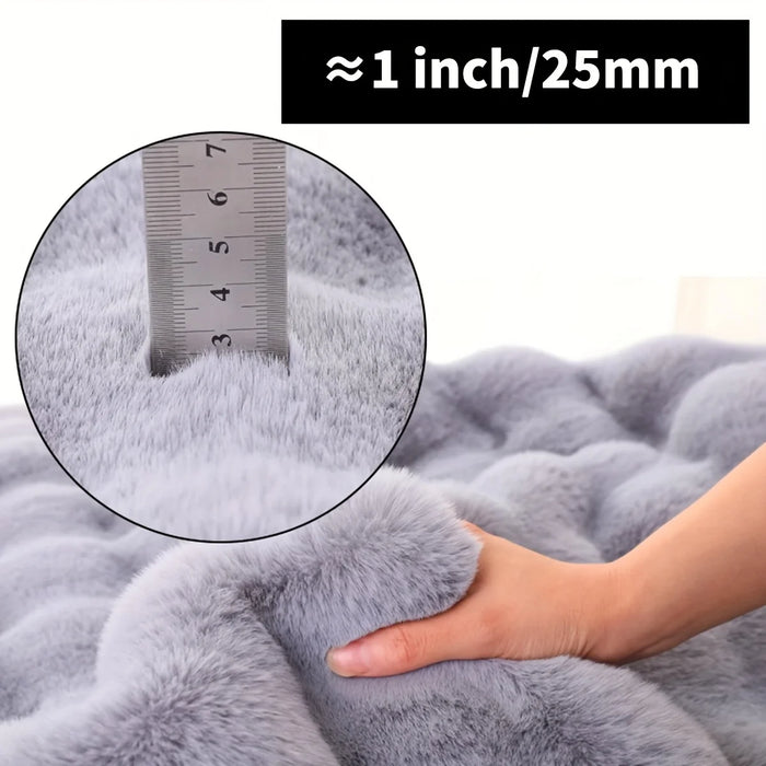 Hand pressing the grey faux fur pile, about 25 mm deep