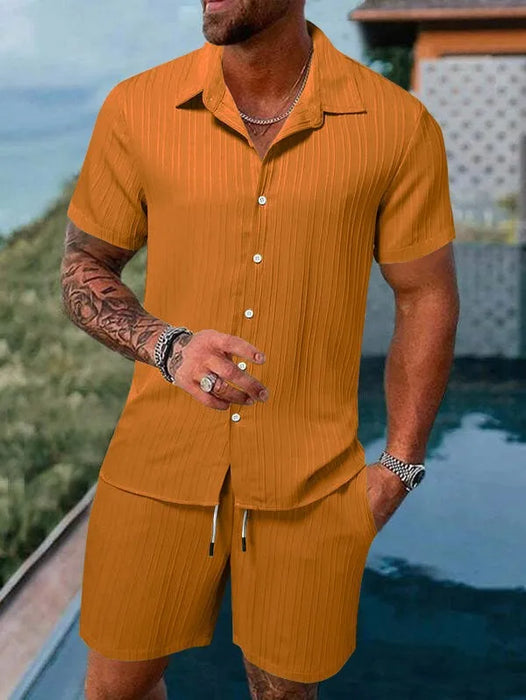 Man in an orange short sleeve shirt and shorts set