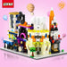 Mini shop building block models with balloons on a pink background
